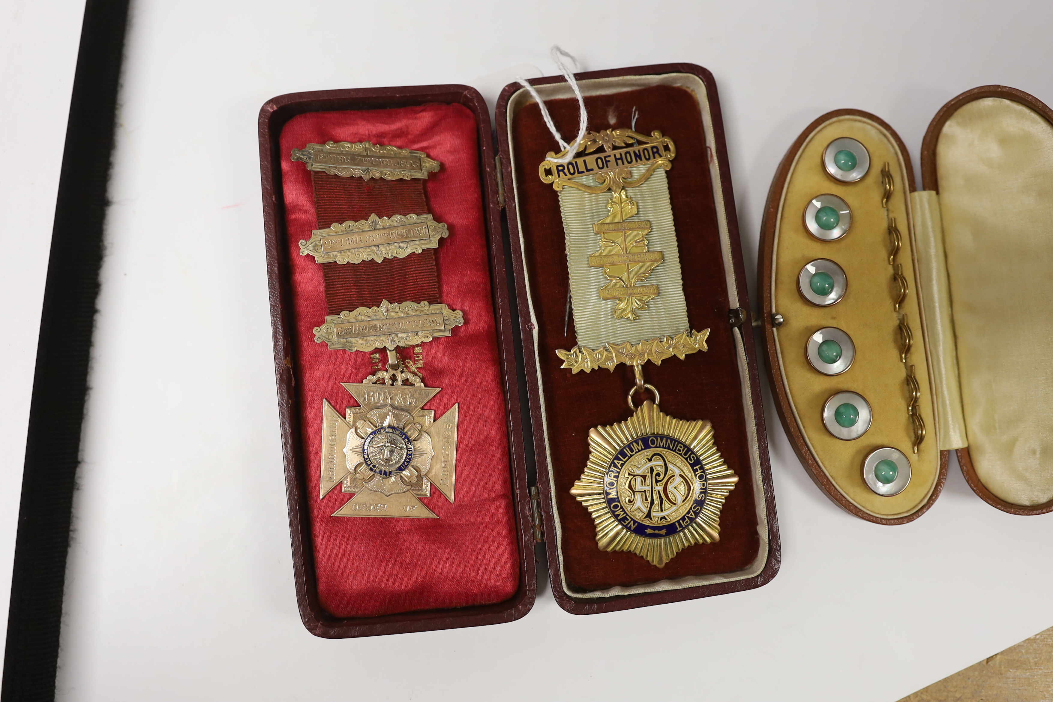 A late Victorian 9ct and enamel masonic jewel and a later Edwardian 9ct gold and enamel masonic jewel, gross weight 46.5 grams, together with a cased gilt metal and paste dress stud set